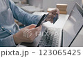 Man holding credit card while using laptop, shopping online, buying on internet. 123065425