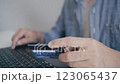 Man holding credit card while using laptop, shopping online, buying on internet. 123065437