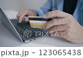 Man holding credit card while using laptop, shopping online, buying on internet. 123065438
