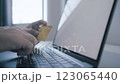 Man holding credit card while using laptop, shopping online, buying on internet. 123065440