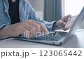 Man holding credit card while using laptop, shopping online, buying on internet. 123065442