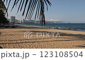 Public beach in Nha Trang, Vietnam. Beautiful view of the embankment, mountains, beach and South China Sea. Tourists and locals relax and swim. Handheld shooting in slow motion. Overview. 123108504