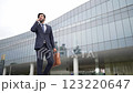 Smart business man using phone to talking while walking at building. Exultant. 123220647
