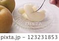Pierce the cut Japanese pear with a fork 123231853