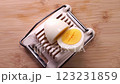 Slice boiled eggs with an egg slicer 123231859