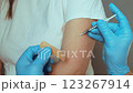 Medical staff prepares to administer a vaccination to a patient. The session focuses on the importance of immunization for health and safety. The setting is clean and professional, emphasizing care 123267914