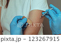 A healthcare professional administers a vaccination to a patient in a clinical environment. The process emphasizes the role of inoculation in preventing diseases and promoting public health 123267915