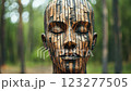 Wooden sculpture of a woman's head in a forest 123277505