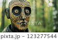 Wooden statue observing forest surroundings 123277544