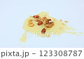 Walnuts and pine nuts, almonds and cashews lie on a white background in a puddle of yellow liquid honey, honey dripping on top of them. The concept of sweet natural desserts, diet, snacks. High 123308787
