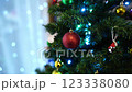 Sparkling balls and luminous garlands on the green branches of the Christmas tree 123338080