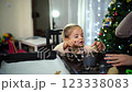 Little girl holds a cookie cutter in her hands while her mother molds the dough 123338083
