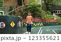 Pensive young boy standing alone in a whimsical outdoor setting park Pensive young boy standing alone in a whimsical outdoor setting park 123355621