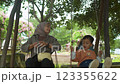 Mother and son enjoying quality time on swings in lush green garden Mother and son enjoying quality time on swings in lush green garden 123355622