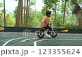 Young boy enjoying a bike ride in the park on a sunny day outdoors Young boy enjoying a bike ride in the park on a sunny day outdoors 123355624