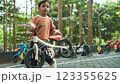 Young boy practices balance on a bike in a vibrant outdoor park setting Young boy practices balance on a bike in a vibrant outdoor park setting 123355625