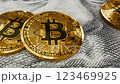 Golden crypto bitcoin coins on a 100 dollar bill featuring Benjamin Franklin 123469925