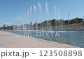 The Stavros Niarchos Foundation Cultural Center with visitors strolling around the pool with fountains The Stavros Niarchos Foundation Cultural Center with visitors strolling around the pool with fountains 123508898