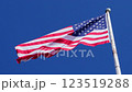 USA flag on a flag pole blowing in the wind against deep blue sky, shot in slow motion 123519288