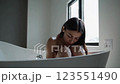 Woman Sitting in Bathtub Scene with Natural Light Footage 123551490