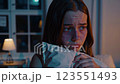 Emotional Scene of a Young Woman Holding a Pillow in Dim Light Footage 123551493