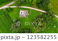 A large field of green grass with a small building in the middle. Top view. Rotate. 123582255
