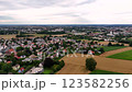 Aerial view of city with a lot of houses and a field in the background. 123582256
