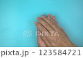 Footage video 4k. Hands holding pink ribbon on blue background. Breast cancer Awareness, male breast cancer disease, World Cancer Day. Healthcare or hospital and insurance concept. 123584721