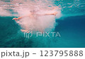 A delightful and joyful moment of a young boy swimming underwater, showcasing the fun and vibrant aquatic life 123795888