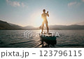 Paddleboarding during a breathtaking sunset 123796115
