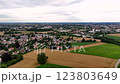 Aerial view of city with a lot of houses and a field in the background. 123803649