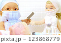 Toy doctor and doll nurse under treatment of sick little doll  123868779