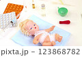 Toys medical treatment of sick little doll  123868782