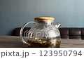 The camera smoothly zooms in on the teapot, inside which tea is being brewed. The process of heat condensation. Lemon, rosehip, cherry and other ingredients are floating inside the kettle 123950794