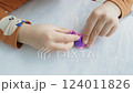 a child's hand playing with clay, slowmotion 124011826