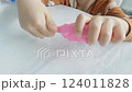 a child's hand playing with clay, slowmotion 124011828