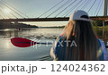 Woman paddling on a kayak under the bridge 124024362