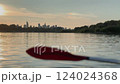 A blured kayak paddle with Warsaw city skyline  view in the background from the water 124024368