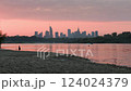 Warsaw skyline cityscape view from the side of Vistula river during pink summer sunset with boat on a water surface 124024379