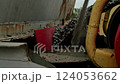 Crushed stone and sand being discharged from an industrial conveyor system at a construction site. Close-up view of heavy machinery in operation 124053662