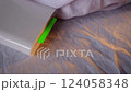 A compact pocket-sized white printer on bed prints polaroid style photo with green screen in minimalist design modern technology creative process cozy atmosphere vibrant details portable convenience 124058348