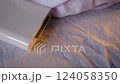 A compact pocket-sized white printer on bed prints polaroid style photo with green screen in minimalist design modern technology creative process cozy atmosphere vibrant details portable convenience 124058350
