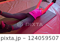 Woman exercising with resistance bands in fitness routine 124059507