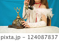 Girl child in vintage clothes posing with retro phone 124087837