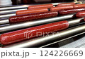 Delicious hot dogs are sizzling on a roller grill, making them the perfect choice for outdoor gatherings and events 124226669