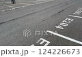 A wide and spacious view of an empty parking lot featuring marked parking spaces E204 and E205 clearly visible 124226673