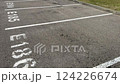 A wide and spacious view of an empty parking lot featuring marked parking spaces E204 and E205 clearly visible 124226674