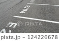 A wide and spacious view of an empty parking lot featuring marked parking spaces E204 and E205 clearly visible 124226678