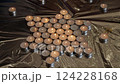 Burning tealight candles arranged in a star shape on reflective metallic foil background. Candlelight and remembrance concept for design and print 124228168