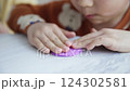 a child's hand playing with clay 124302581